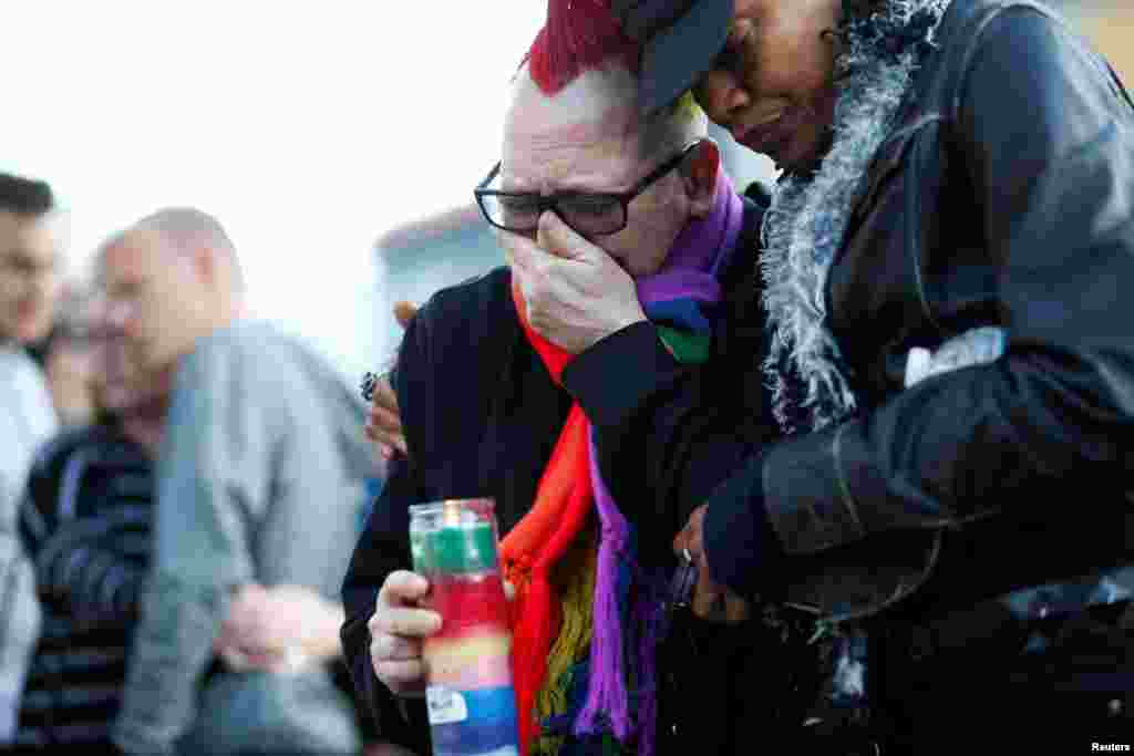 Trashina Cann (left) and Vixen Noir, both of San Francisco, attend a candlelight vigil for the victims of the June 12 attack in Orlando, Florida.