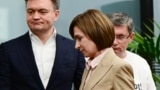 Moldovan President Maia Sandu (center) leaves a press conference at her campaign headquarters in Chisinau on October 21.