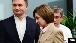 Moldovan President Maia Sandu (center) leaves a press conference at her campaign headquarters in Chisinau on October 21.