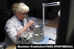 A technician works on a hydraulic component of the MC-21 in a factory near Moscow in September 2019.