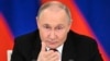 Russian President Vladimir Putin gestures as he speaks to journalists at the Kremlin early on May 11.