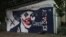 Kazakhstan - Nazarbayev's mural on a garage wall in Almaty was repainted portraying him as Joker.
