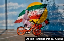 A woman rides a bicycle in Tehran. The simple act of a woman riding a bicycle -- even while wearing a head scarf -- has been a controversial issue in Iran. Hard-liners, including influential clerics, have repeatedly spoken out against it.