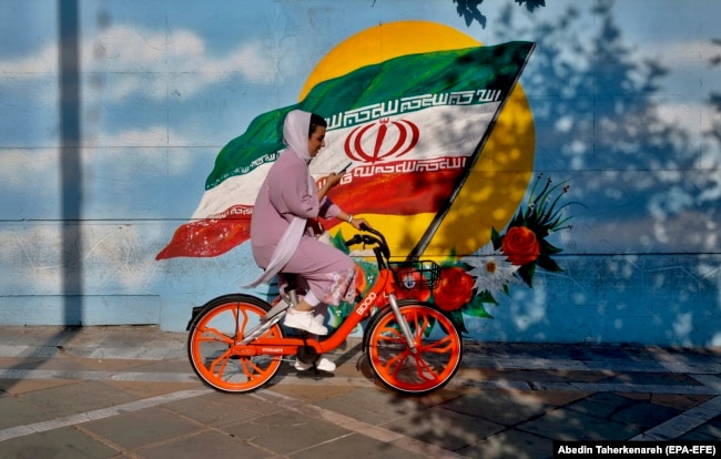 A woman rides a bicycle in Tehran. The simple act of a woman riding a bicycle -- even while wearing a head scarf -- has been a controversial issue in Iran. Hard-liners, including influential clerics, have repeatedly spoken out against it.