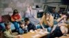 A family takes shelter in a cellar in Sarajevo on June 6, 1992, as shells fall on the Bosnian capital. The fighting continued, despite a UN-brokered deal to reopen the airport and for Serbian troops to withdraw from their barracks in the center of the city.&nbsp;