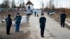 Police officers wearing face masks to protect against the coronavirus guard an entrance to Correctional Colony No. 2 in Pokrov on April 6.