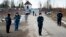 Police officers wearing face masks to protect against the coronavirus guard an entrance to Correctional Colony No. 2 in Pokrov on April 6.