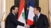 French President Emmanuel Macron (R) shakes hands with Lebanese Prime Minister Saad Hariri during a press conference at the Murat Lounge in the Elysee Palace in Paris, September 1, 2017