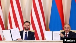 U.S. Vice President JD Vance and Armenia's Prime Minister Nikol Pashinian hold signed copies of a joint statement on the completion of negotiations on a U.S.-Armenian nuclear agreement, Yerevan, February 9, 2026.