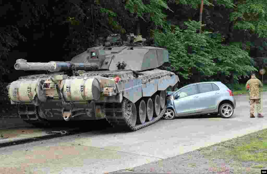 A British Challenger 2 tank rolled over a car in the German town of Lippe. A novice driver apparently overlooked a convoy of tanks when she turned left onto the Panzeringstrasse (literally, Tank Ring Road). The driver of the convoy&#39;s leading tank was not able to stop his vehicle fast enough. The young driver was unhurt. (epa)