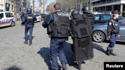 Париждегі Халықаралық валюта қорының кеңсесі жанында хатқа жасырылған бомба жарылғаннан кейін жүрген полиция қызметкерлері. Франция, 16 наурыз 2017 жыл.