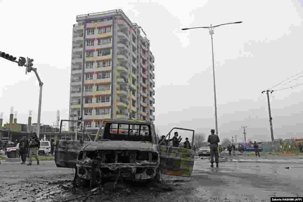 Members of the Afghan security forces stand guard at the site of the attack.