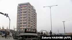 Members of Afghan security forces stand guard at the site of an attack in Kabul on December 20.