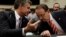 FBI Director Christopher Wray (left) and Deputy U.S. Attorney General Rod Rosenstein chat before a House Judiciary Committee hearing in Washington on June 28.
