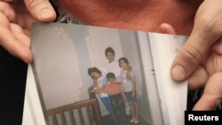 Patimat Suleimanova, aunt of Boston Marathon bombing suspects Dzhokhar and Tamerlan Tsarnaev, holds a photo from the family archive at her house in Makhachkala, 22Apr2013