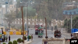 Police and soldiers near the U.S. Embassy in the Yemeni capital following an attack in September 2008.