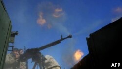 A member of the Afghan security force fires at the Islamic state (IS) group fighters in Achin district of Nangarhar province, December 2015.