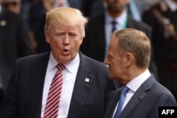 U.S. President Donald Trump (left) speaks with the president of the European Council, Donald Tusk, at the G7 summit.