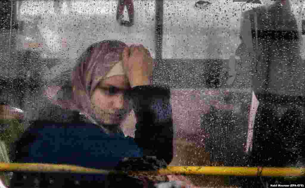 A Syrian woman looks through the window of a bus as refugees prepare to leave Beirut on their way home to Syria. A group of some 1,300 Syrian refugees began their trip home from different areas in Lebanon as part of a coordinated operation between authorities in Beirut and Damascus. (epa-EFE/Nabil Mounzer)