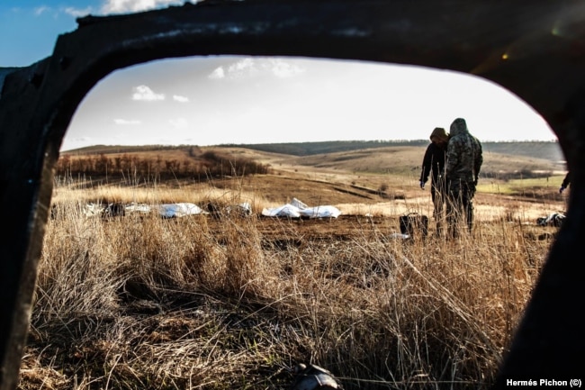 Ukrainian volunteers collect the remains of Ukrainian and Russian soldiers in Kharkiv last month,