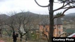 The activists say cottages were illegally built on the land controlled by Governor Aleksandr Tkachev.