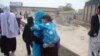 Norouz celebrations included trips to holy shrines, like that of this Afghan woman and her son in Kabul.