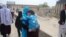 Norouz celebrations included trips to holy shrines, like that of this Afghan woman and her son in Kabul.