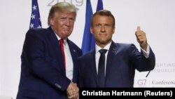 French President Emmanuel Macron shakes hands with U.S. President Donald Trump after a joint press conference at the end of the G7 summit in Biarritz, France, August 26, 2019