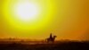 AFGHANISTAN -- A man rides a horse at sunset near the Pashtoon Pul in Injil district of Herat province, October 7, 2020