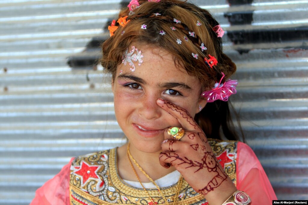 An Iraqi girl is seen as she celebrates Eid al-Fitr, a festival to mark the end of the Muslim holy month of Ramadan, in Mosul. (Reuters/Alaa Al-Marjani)