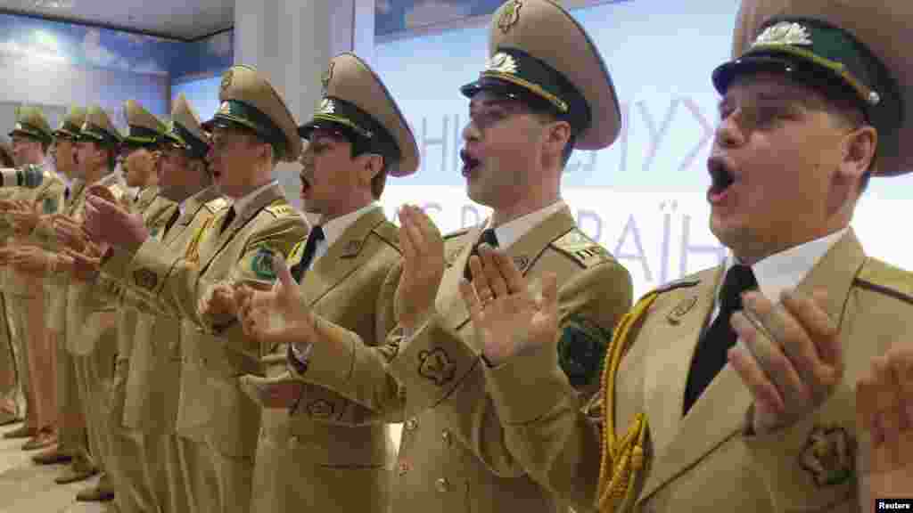 Musicians from Ukraine's Border Guards band take part in a show to present a new soccer anthem in the arrival area of Borispol airport on March 21 ahead of the Euro 2012 tournament. (Reuters/Gleb Garanich)