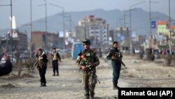 AFGHANISTAN -- Afghan security personnel gather at the site of bomb explosion in Kabul, February 26, 2020