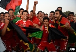 Afghan footballers celebrate their 3-0 win against Pakistan.