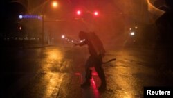 Человек пытается устоять на ногах во время сильного шторма. Штат Техас, США, 25 августа 2017 года.