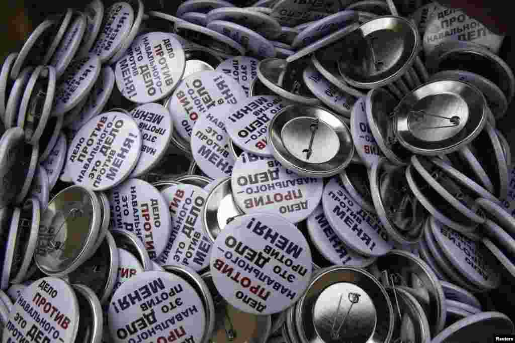 Badges with the slogan "The Case Against Navalny Is The Case Against Me" are seen before being distributed.
