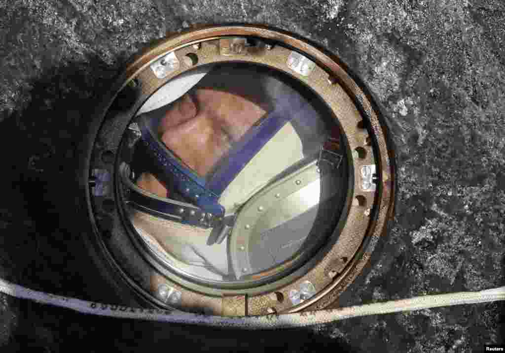 Russian cosmonaut Oleg Artemyev looks out of a Russian Soyuz space capsule shortly after landing near Dzhezkazgan, Kazakhstan, on September 11, following a six-month stay at the International Space Station. (Maxim Shipenkov, Reuters)