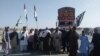 Activists of Pakistani political parties Jamiat Ulam-e Islam and Pashtunkhwa Milli Awami Party block a road leading to the southwestern city of Quetta, the capital of Balochistan Province.