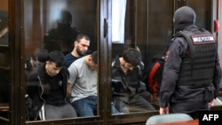 A group of the defendants pictured in a Moscow courtroom in August 2025