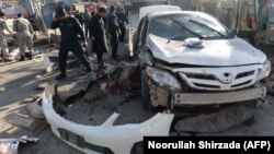 Afghan security forces inspect the site of the suicide attack in Jalalabad on March 7.