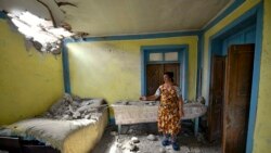 Azerbaijan -- A local woman shows damage in her house after shelling by Armenian forces in the Tovuz region, July 14, 2020