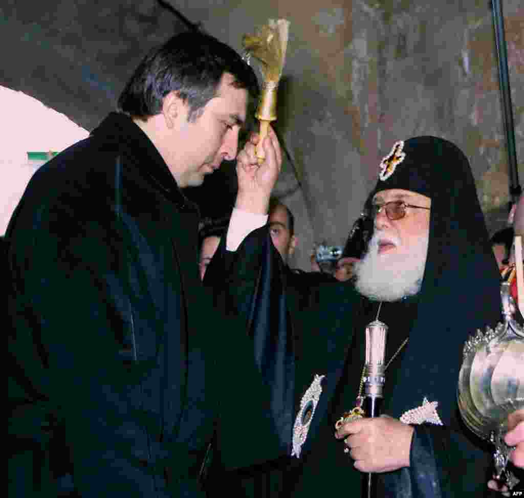 The head of the Georgian Orthodox Church, Catholicos Ilia II (right), blesses newly elected President Mikheil Saakashvili at the Gelati Cathedral in Kutaisi on January 24, 2004.