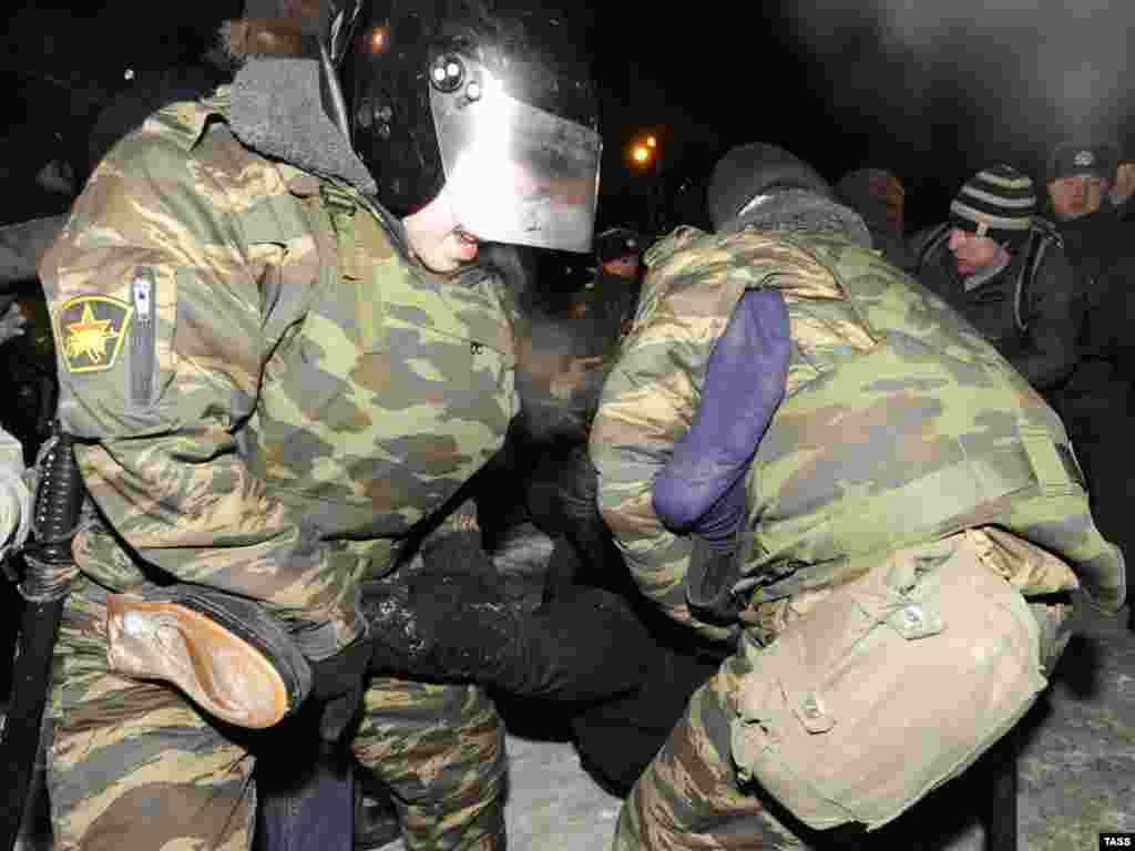 Russian police detain a participant of an antifascist rally in Moscow on January 19. - Demonstrators staged a rally against neofascism in memory of lawyer Stanislav Markelov and journalist Anastasia Baburova, who were murdered a year ago. Police claimed that the march following the rally was unsanctioned and arrested 24 protesters. Photo by Andrey Stenin for ITAR-TASS