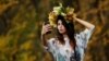 RUSSIA -- A woman takes a selfie with yellow leaves in a park in Moscow, Russia October 14, 2020.