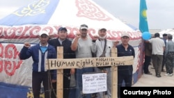 Aitbai Aliev (center) and other activists take part in a commemoration event earlier this month for rights activist Dulat Aghadil, who died in February.