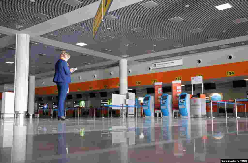 Deserted check-in desks in the empty departures hall at Moscow&#39;s Sheremetyevo International Airport on March 27