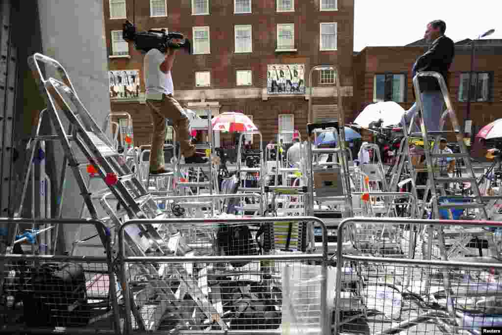 A reporter with Britain&#39;s Sky News, Paul Harrison, speaks on live television in the media pen opposite the Lindo Wing.