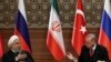 TURKEY -- Iranian President Hassan Rohani (L) and Turkish President Tayyip Erdogan gesture during a joint press conference with Russian president, as part of a tripartite summit on Syria, in Ankara, April 4, 2018