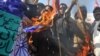 Pakistani activists burn an Indian flag in Lahore to protest the attack on the Sri Lankan cricket team. Pakistan claims the attack was similar to the November attacks in Mumbai