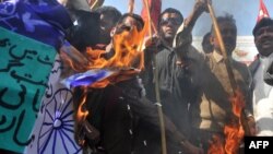 Pakistani activists burn an Indian flag in Lahore to protest the attack on the Sri Lankan cricket team. Pakistan claims the attack was similar to the November attacks in Mumbai
