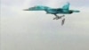 A still image taken from video footage and released by Russia's Defence Ministry on August 18 shows a Russian Sukhoi Su-34 fighter bomber based at Iran's Hamadan air base dropping bombs in the Syrian province of Deir ez-Zor.